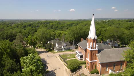 Aerial-View-of-Small-Town-USA-and-Classic-Church-with-White-Steeple
