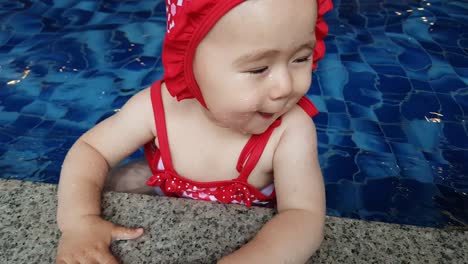 Caucasian-Baby-Girl-In-Cute-Swimwear-Enjoying-Water-In-An-Indoor-Swimming-Pool