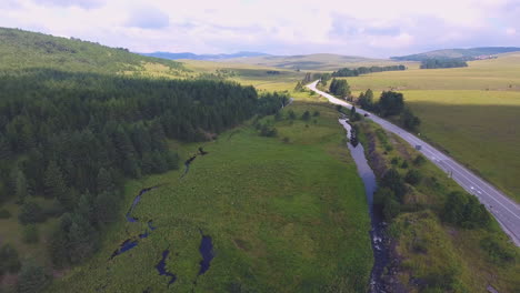 Travelling-towards-the-Siberian-landscapes-by-road-with-the-amazing-view-of-river-and-forest,-A-drone-view