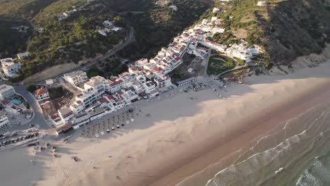 Aerial-perspective-of-idyllic-Praia-da-Salema-beach-in-Algarve-Portugal