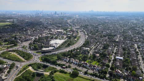 Leyton-and-Leytonstone-East-London-Waltham-forest-London-skyline-in-background-rising-drone-footage-4K