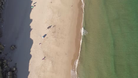 Birds-eye-view-of-the-crystal-clear-water-at-Salema-beach-during-golden-hour