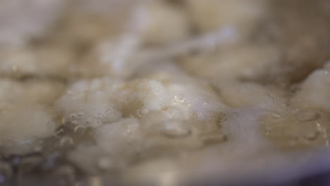 Close-up-of-cauliflower-boiling-in-a-pot-on-the-stove---slow-motion