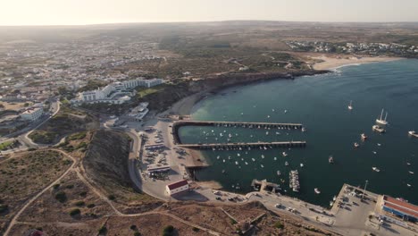 Rotating-aerial-of-the-port-of-Sagres,-Portugal-during-golden-hour