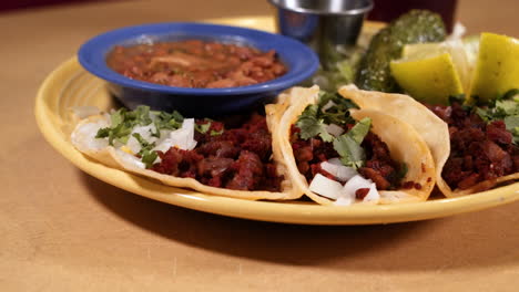 Traditional-Mexican-pastor-taco-plate-at-restaurant,-slider-close-up-HD