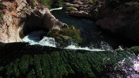 Aerial-View-of-Top-of-Waterfall-in-Wilderness-on-Sunny-Summer-Day,-Freshwater-in-Nature,-Drone-Shot