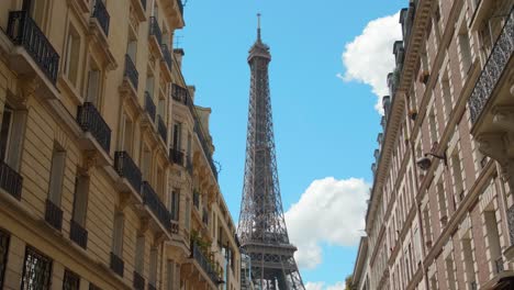 Eiffel-Tower,-Paris,-France,-Street-View-Between-Buildings-in-Typical-Haussmann-Architecture