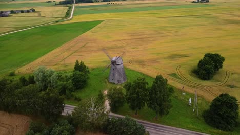 aerial-shot-of-an-old-windmill-in-the-field,-parallax-shot