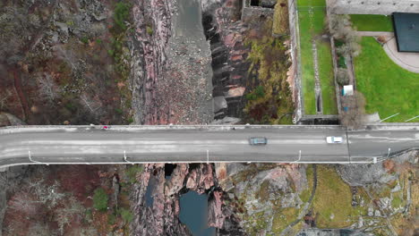 Static-aerial-bird-eye-view-from-above-of-Oskarsbron-Oskar-bridge-at-the-dried-out-Trollhättan-waterfalls-and-locks-in-Sweden-with-vehicles-crossing-the-road-bridge