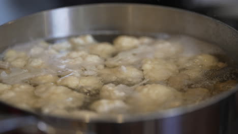 A-hot-pot-of-boiling-cauliflower---bubbling-steamy-water-isolated-in-slow-motion