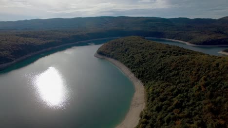 Aerial-shot-of-Lake-Lac-de-Vouglans-on-the-River-Ain-in-France-during-sunset