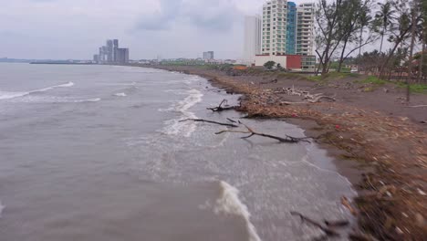 Aerial-rising-forward-view-polluted-contaminated-beach-Veracruz-cloudy-day
