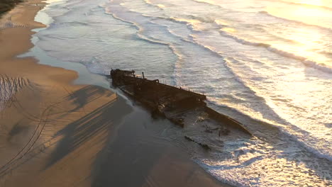 Orbiting-drone-time-lapse-of-the-SS-Maheno-shipwreck-on-Fraser-Island,-Australia