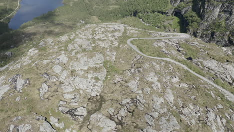 Drone-shot-of-a-small-road-and-mountains-in-Norway