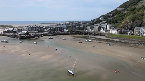 Barmouth-harbour-with-tide-out-North-Wales,-UK-aerial-footage