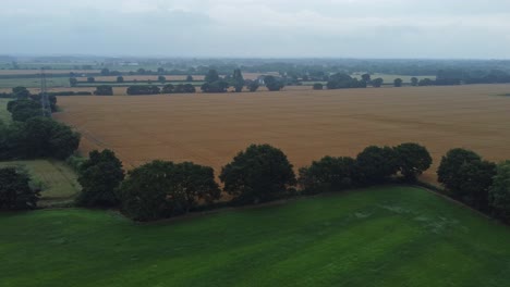 Hazy-morning-across-UK-British-farming-countryside-rolling-agriculture-aerial-view-landscape