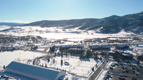 Snowy-Rooftops-And-Tranquil-Winter-Mountain-Scenery-In-Colorado---Aerial-drone-pan-right