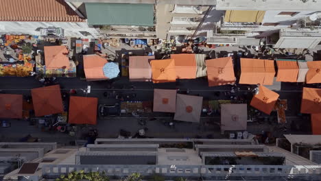 Aerial-drone-shot-twisting-over-urban-street-market-Exarcheia-Athens-Greece