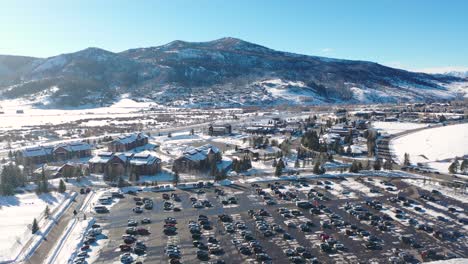 Cars-In-Parking-Spaces-At-Ski-Resort-and-Lodges-In-Snow-During-Winter-In-Steamboat-Springs,-Colorado