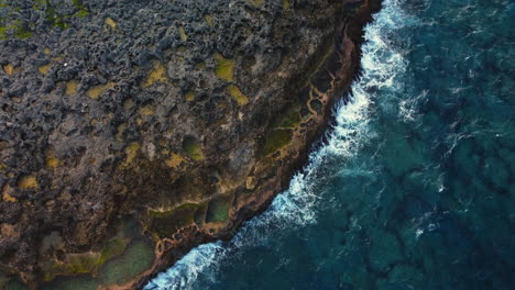 Aerial-pullout-of-Cap-des-Pins-in-Lifou-island,-rugged-Pacific-coastline-cliffs
