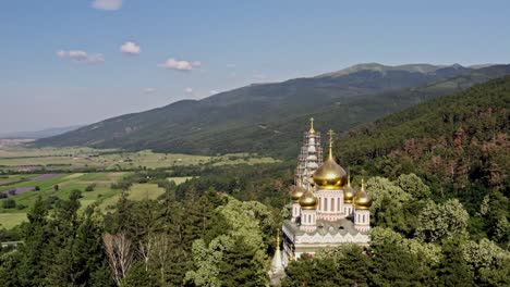 Aerial-view-of-Shipka-memorial-church-amid-dense-forest-at-the-foot-of-Balkan-mountains-Bulgaria