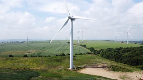 Wind-Turbine-rotating-in-field-on-cloudy-hot-summer-day