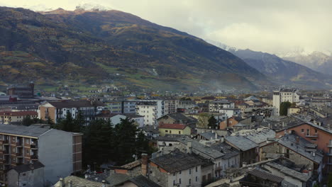 A-majestic-look-of-the-Valle-d’Aosta,-Italy,-with-amazing-clave-of-mountains,-and-rooftops,-Drone-view