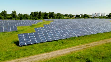 Aerial-low-angle-truck-showing-large-solar-panels-farm-during-sunny-day-in-rural-landscape