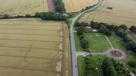4K-drone-video-showing-a-country-road-with-a-cemetery-along-side-it