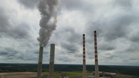 Smokestacks-with-a-cloudy-sky-background