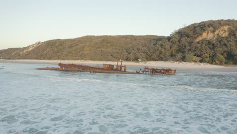 Aerial-shot-of-the-old-shipwreck,-SS-Maheno,-on-a-beach-of-Fraser-Island,-Australia