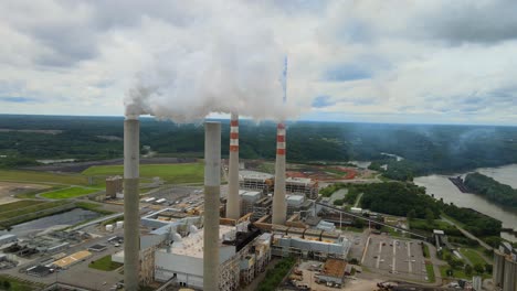 Aerial-orbit-of-smokestacks-at-a-fossil-plant,-located-on-the-Cumberland-River-in-Tennessee
