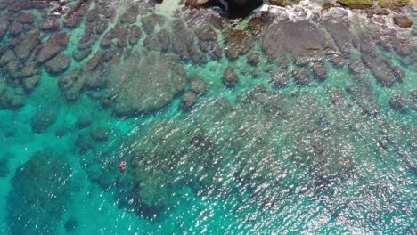 Aerial-tracking-shot-straight-down-looking-at-beautiful-clear-blue-sea-and-ocean-reef-in-bright-daylight-at-Xiaoliuqiu-Lambai-island,-Pingtung-county,-Taiwan