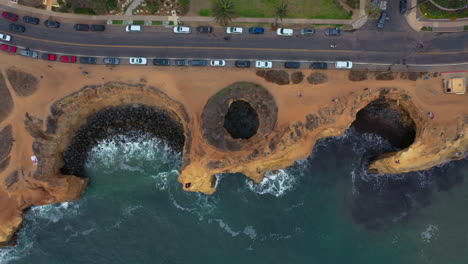 Top-down-Drone-View-Of-Luscomb's-Point-And-Sunset-Cliffs-Cave-In-San-Diego,-California