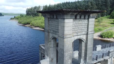 Alwen-reservoir-Welsh-woodland-lake-water-supply-aerial-closeup-view-concrete-dam-countryside-park-pulling-back