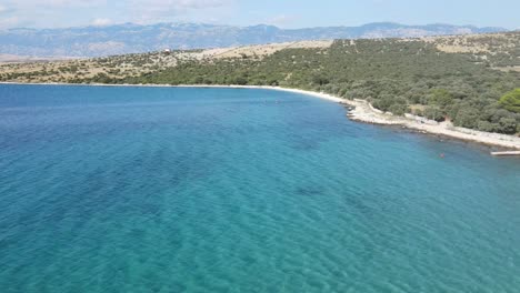 An-aerial-footage-over-Adriatic-Sea-on-island-Pag,-Croatia-near-Mandre