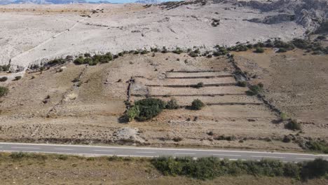An-aerial-view-over-scorched-stoney-sheep-pastures-on-an-island-of-Pag,-Croatia