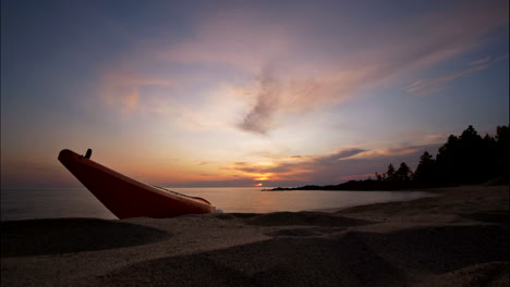 Time-Lapse-Sunset-With-Kayak-At-Beach-And-Sea