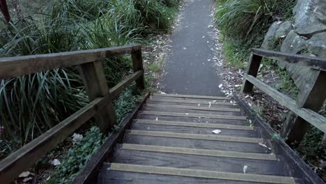 POV-Of-Person-Walking-Down-The-Rustic-Wooden-Stairs-In-A-Park-Near-Paddington,-NSW-Australia