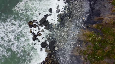 4K-30FPS-Aerial-Footage-Oregon-Coast---Waves-Crashing-Against-the-Rocky-Moss-Shore,-Turquoise-Blue-Water,-Foamy-Water,-Contrast--Top-Down-Shot-of-Pacific-Ocean-Shore-in-South-Oregon---DJI-Drone-Video