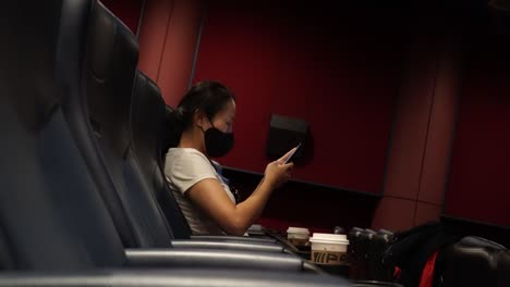 Asian-Woman-Spending-Time-Alone-In-Empty-Cinema