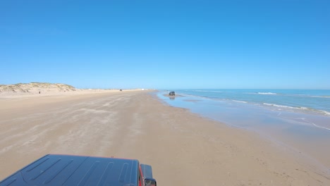 POV-from-the-roof-top-while-driving-on-the-beach-past-few-others-on-the-beach---South-Padre-Island,-Texas