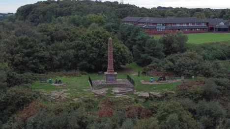 Aerial-view-sandstone-obelisk-war-memorial-Frodsham-hill-overlooking-Cheshire-Liverpool-skyline