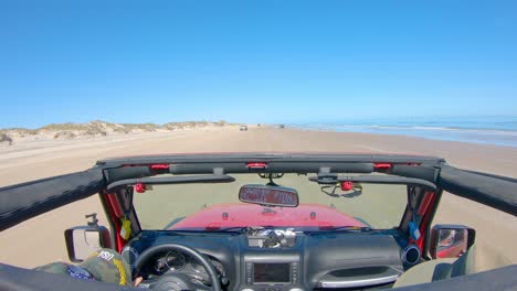 POV-while-driving-past-vacationers-while-on-the-beach,-roof-top-removed-from-off-road-vehicle---South-Padre-Island,-Texas