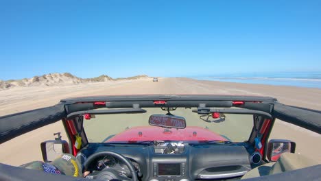 POV-from-the-roof-top-while-driving-on-the-beach-with-sand-dunes-on-barrier-island-of-the-Gulf-of-Mexico---South-Padre-Island,-Texas