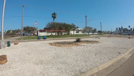 POV,-drivers-window-point-of-view-while-driving-a-residential-road-on-North-Padre-Island,-Texas