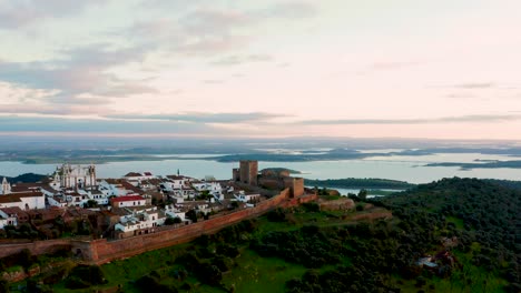 Historic-Monsaraz-castle-overlooking-river,-Portugal,-panoramic-aerial-view