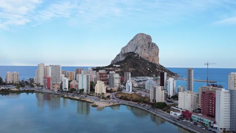 Aerial-recording-with-truck-movement-to-the-left-of-Lake-Les-Salines-in-the-foreground-and-in-the-background-the-Penyal-d'Ifac-Natural-Park-in-Calp,-Alicante,-Spain