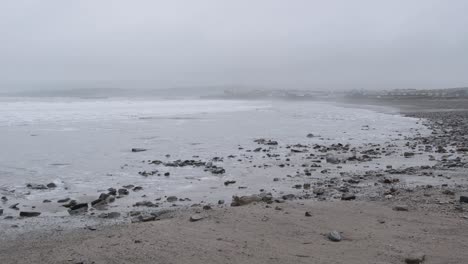 Fogged-beach-hit-by-waves-during-storm