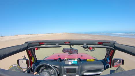 POV-from-the-roof-top-while-driving-on-the-beach-at-low-tide-on-barrier-island-of-the-Gulf-of-Mexico---South-Padre-Island,-Texas